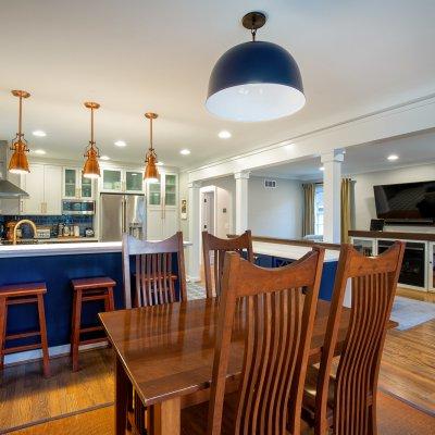 Kitchen and eating area blue and white with copper light fixtures